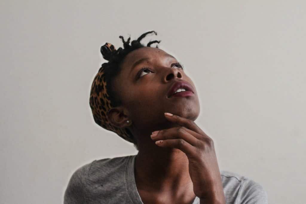 A black girl looking up and thinking