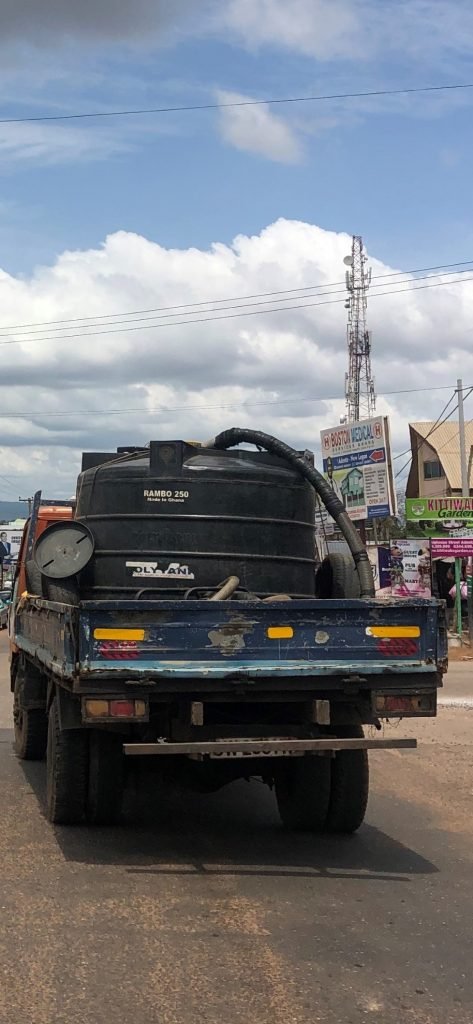 Polytank with hose on blue truck